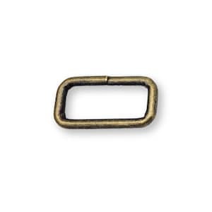 May include: A rectangular metal buckle with rounded corners, in an antique brass finish. The buckle is a single piece with a slight gap on one side, suggesting it can be opened or closed. The hardware is set against a white background.