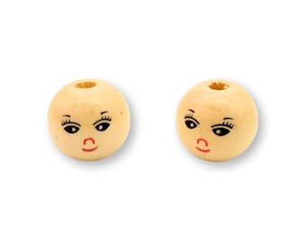 May include: Two wooden beads with painted faces. Each bead has black eyes, eyelashes, and a red mouth.