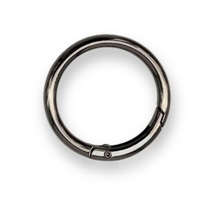 May include: A black metal key ring with a swivel clasp.