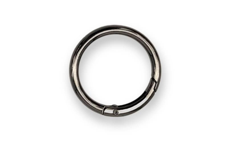 May include: A black metal key ring with a swivel clasp.