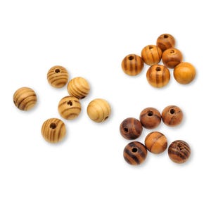 May include: A collection of wooden beads in various shades of brown and beige. Some beads have a striped pattern, while others are solid.