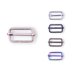 May include: Five metal slider buckles in different finishes: silver, black, bronze, and iridescent. The buckles are rectangular with a centre bar and are approximately 2.5 cm long.