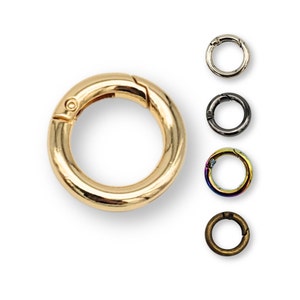 May include: Gold, silver, black, rainbow, and bronze coloured metal key rings. Each ring is a circle with a spring-loaded clasp.