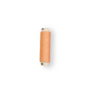 May include: A spool of peach-colored thread.