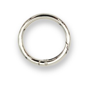 May include: A silver metal key ring with a spring-loaded clasp.