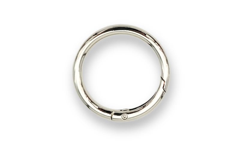 May include: A silver metal key ring with a spring-loaded clasp.