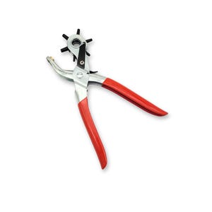 May include: A red-handled metal punch tool with a six-pronged head for creating holes in leather or other materials.