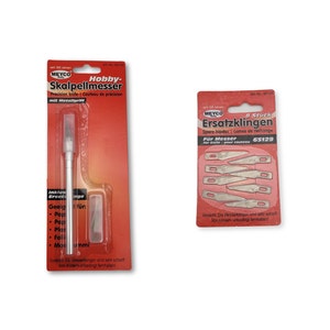 May include: Two packs of hobby knives. The first pack contains a single hobby knife with a metal handle and a spare blade. The second pack contains eight spare blades. Both packs are red and white with the brand name MEYCO.