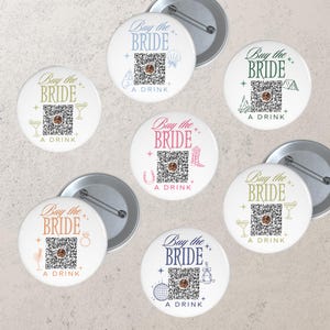 May include: White round buttons with the text "Buy the Bride" and "A Drink" in various colors. Each button features a QR code and a small graphic, such as a seashell, horseshoe, or disco ball. The buttons are for a bachelorette party.