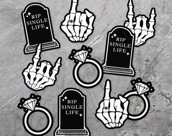 May include: Set of seven black and white stickers featuring a tombstone with the text "RIP SINGLE LIFE", a diamond ring, and a skeleton hand giving the middle finger.