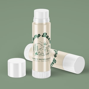 May include: Two white lip balm tubes with a green and white label that says "Camp Back" and "Laura's Bachelorette Sonoma, California".