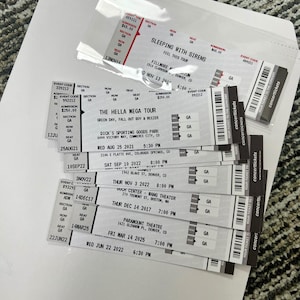 May include: A selection of concert tickets, including tickets for the Hella Mega Tour, Sleeping With Sirens, and other events. The tickets display event details such as dates, times, and venue names.