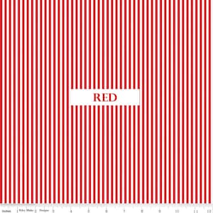 May include: Red and white striped fabric with the word "RED" in a white rectangle. The fabric is marked with inch measurements along the bottom edge.