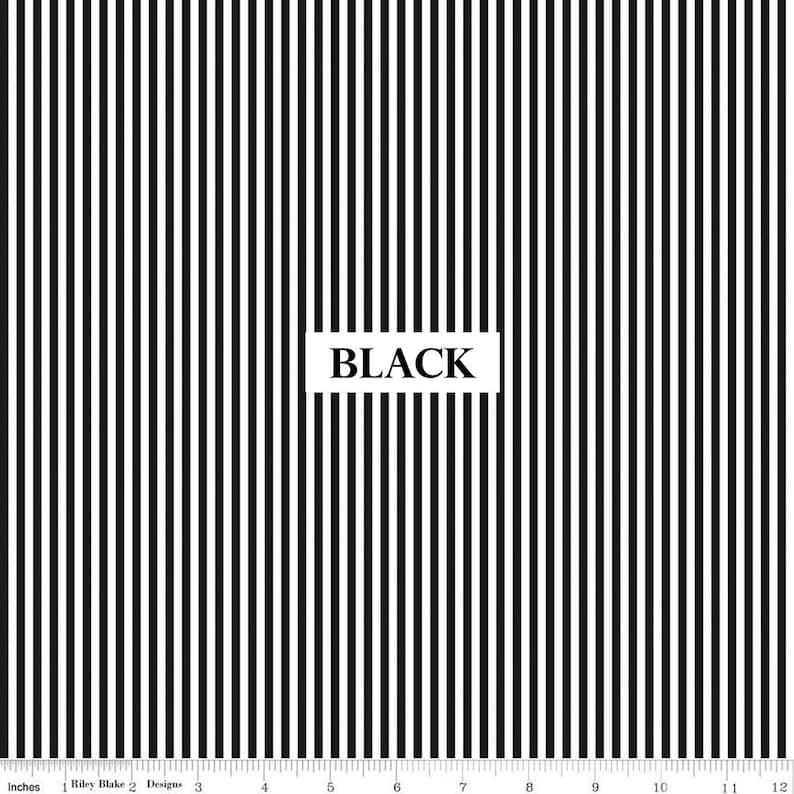 May include: Black and white striped fabric with vertical lines. The word "BLACK" is displayed in a white rectangle. The fabric is measured in inches, with a scale from 1 to 12.