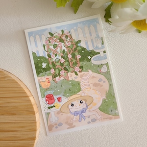 May include: A cartoon illustration of a lizard wearing a straw hat and a blue bow tie sitting at a table with a glass of juice and a small plate of fruit. The lizard is in a garden setting with a rose trellis, a fountain, and two chickens.