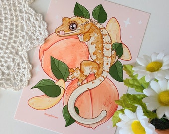 May include: A digital illustration of a crested gecko on a peach background. The gecko is light brown with orange and white markings. The gecko is curled around a peach. The background is pink with white stars.