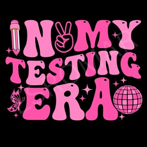 May include: Pink graphic with the text "In My Testing Era" in a retro font. The graphic also includes a peace sign, a pencil, a butterfly, and a disco ball.