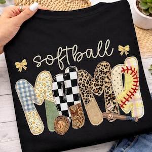 May include: Black t-shirt with the word "softball" in cursive and "MOM" in a patchwork design. The "M" is blue floral, the "O" is black and white checkered, and the "M" is leopard print. A baseball glove and bat are also featured.