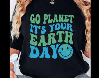May include: Black t-shirt with a green and blue graphic that says "Go Planet It's Your Earth Day" with a smiley face earth graphic.