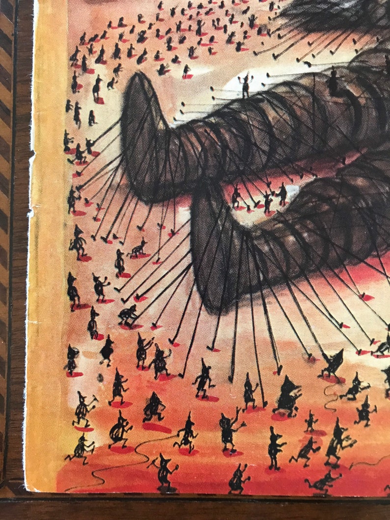 May include: A black and white illustration of a large, dark creature with many small figures pulling on strings attached to it. The figures are all wearing pointed hats and are standing on a red-orange background.