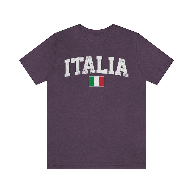 May include: A purple t-shirt with the word "ITALIA" in white with a distressed look and the Italian flag underneath.