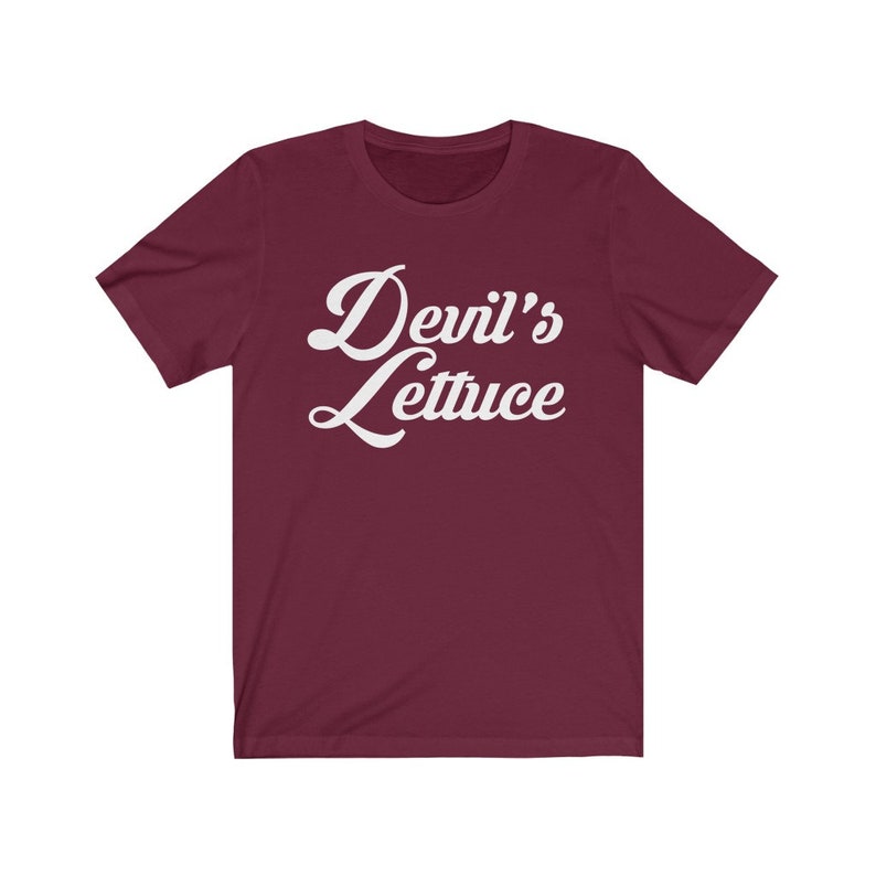 May include: Burgundy short-sleeved t-shirt with white text that reads "Devil's Lettuce" in a retro font.