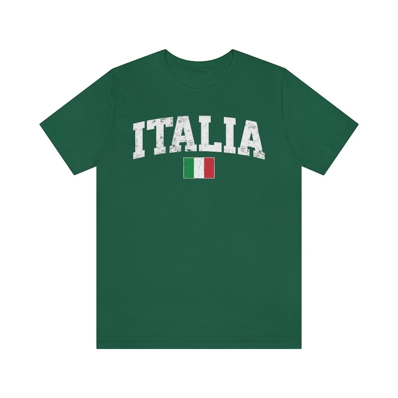 May include: A green t-shirt with the word "ITALIA" in white distressed lettering and a small Italian flag.