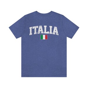 May include: A blue t-shirt with the word "ITALIA" in white distressed lettering and a small Italian flag.
