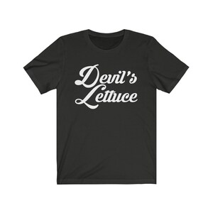 May include: Black t-shirt with white text that reads "Devil's Lettuce" in a retro font.