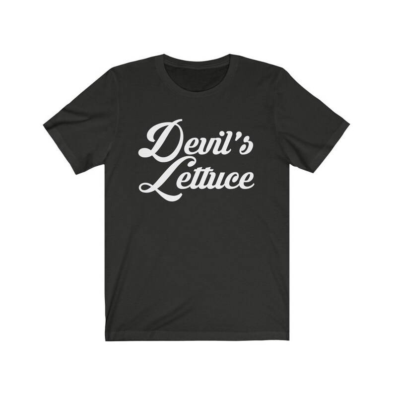 May include: Black t-shirt with white text that reads "Devil's Lettuce" in a retro font.