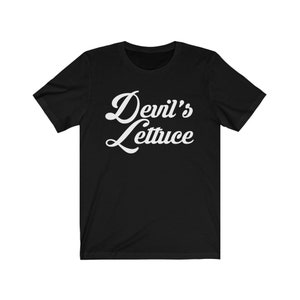 May include: Black t-shirt with white text that reads "Devil's Lettuce" in a retro font.