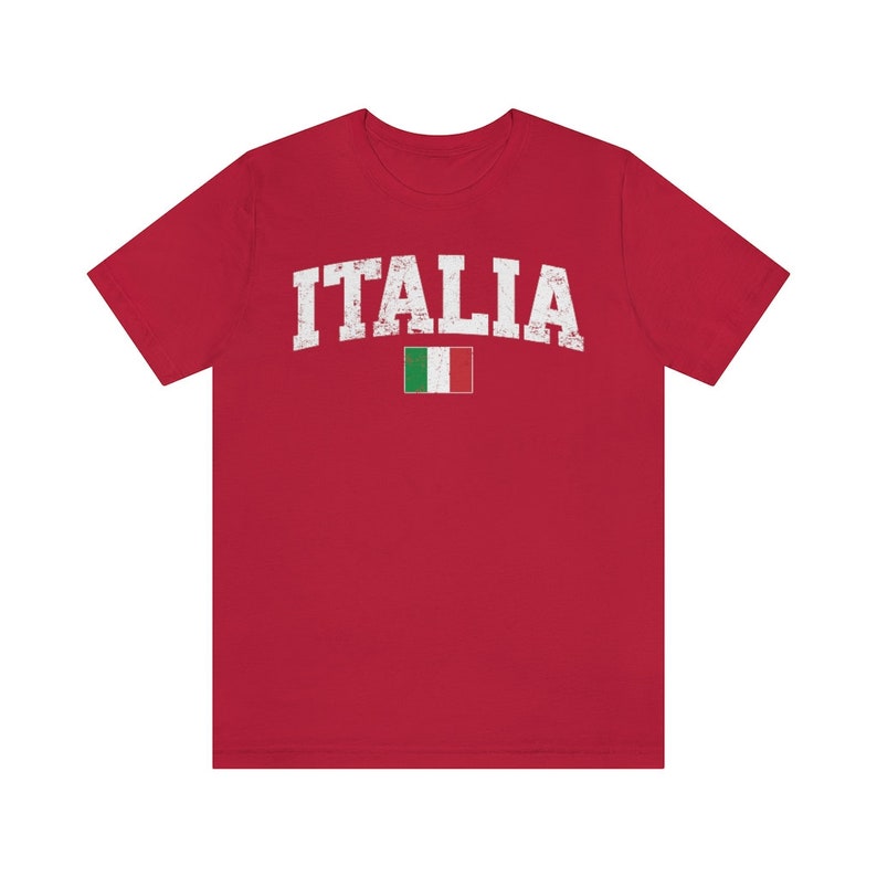 May include: Red t-shirt with a white distressed graphic of the word "ITALIA" and the Italian flag.