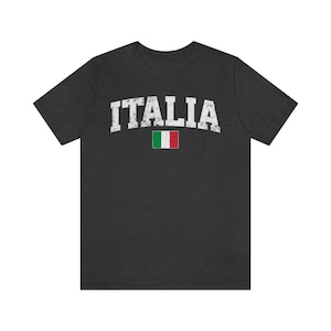May include: A dark heather grey t-shirt with the word "ITALIA" in white distressed lettering and the Italian flag printed below it.