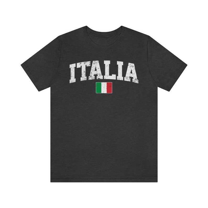 May include: A dark heather grey t-shirt with the word "ITALIA" in white distressed lettering and the Italian flag printed below it.