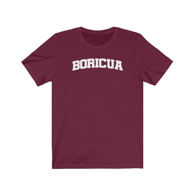 May include: A maroon t-shirt with the word "BORICUA" printed in white on the front.