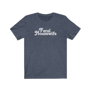 May include: A dark blue t-shirt with the text "Feral Housewife" in white.