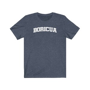 May include: A dark blue t-shirt with the word "BORICUA" printed in white on the front.