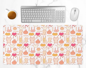 May include: A white mouse pad with a repeating pattern of pink, orange, and yellow cartoon animals. The animals include cats, rabbits, and hearts.