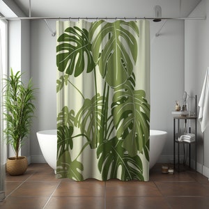 May include: A green and white shower curtain with a tropical leaf pattern. The leaves are large and have a detailed design.