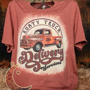 Rusty truck delivery services on Unisex sized bleached heather clay (red/brown) poly/cotton blend t-shirt.