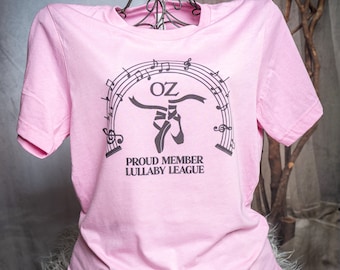 Lullaby League on Unisex sized heather bubblegum pink t-shirt. Based on The Wizard of Oz.