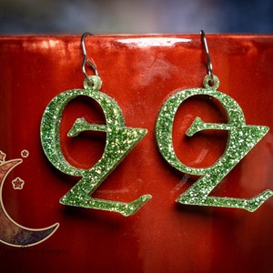 Wizard of Oz earrings made with green glitter or pearlized green acrylic and hypo allergenic french hooks