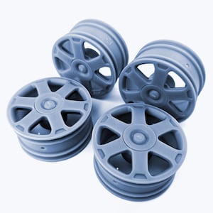 May include: Four grey plastic wheels with a five-spoke design. The wheels are all the same size and have a smooth, matt finish.