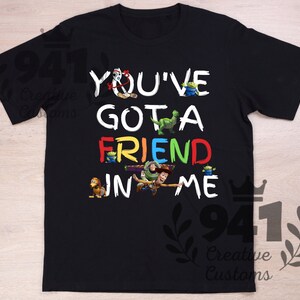 May include: Black t-shirt with a colorful graphic of Toy Story characters and the text "You've Got a Friend in Me."