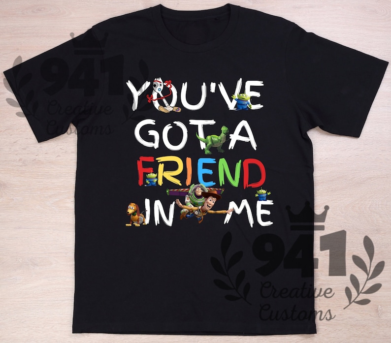 May include: Black t-shirt with a colorful graphic of Toy Story characters and the text "You've Got a Friend in Me."
