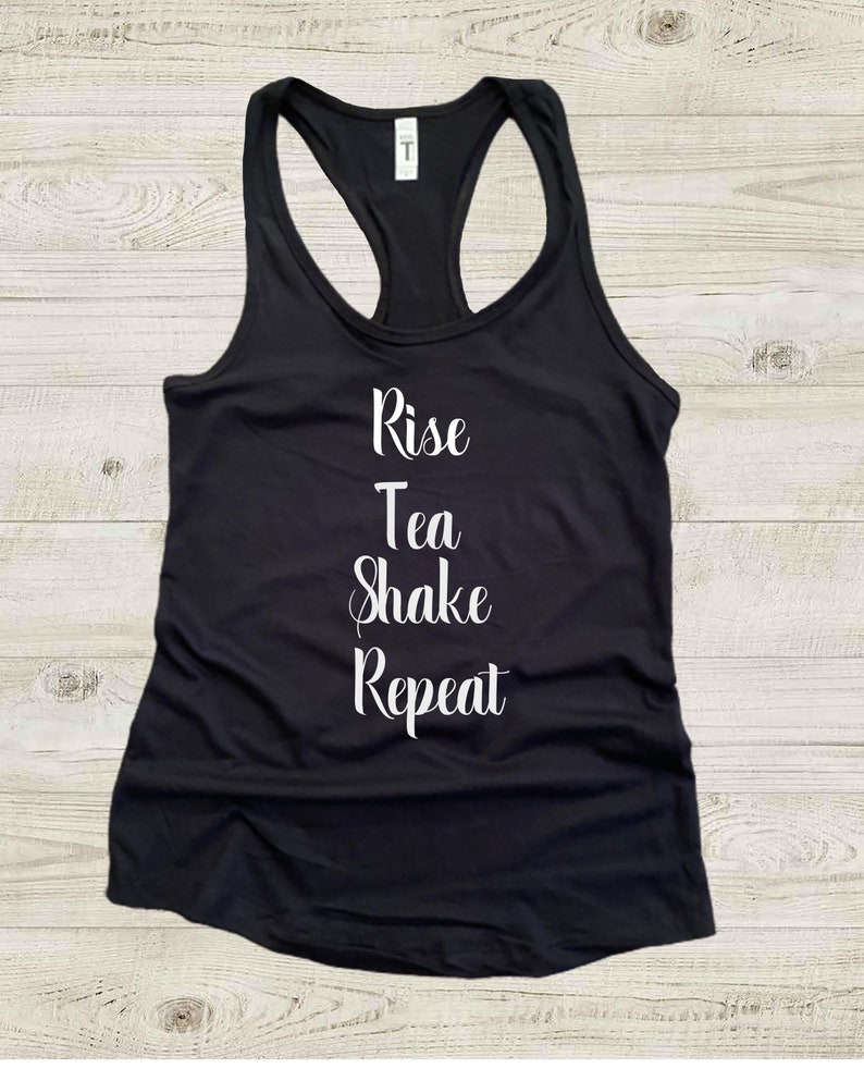 May include: Black tank top with white text that reads "Rise Tea Shake Repeat".