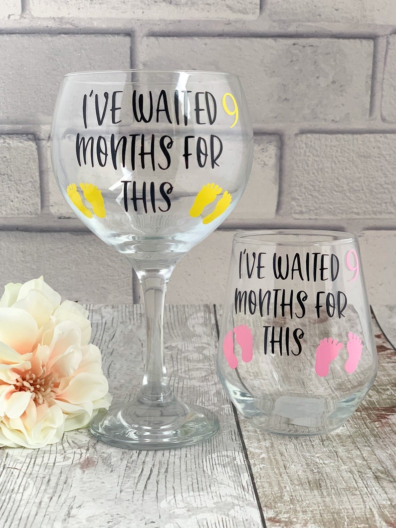 A clear glass with the words I've waited 9 months for this on the front in black.  There are also pink, blue, yellow or white baby feet on the glass, the number 9 matches the colour of the feet.
