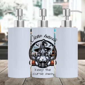 May include: Three white soap dispensers with silver pump tops. The center dispenser features a graphic of a witch with the text "Clean hands, keep the curse away". The witch is wearing a black hat and corset, with pumpkins and candles.