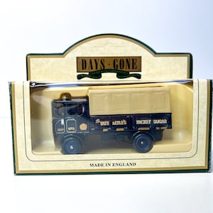 May include: A black toy truck with a white canvas top and the words "Tate Lyle's Packet Sugar" on the side. The truck is in a clear plastic box with a white background and the words "Days Gone" on the top.