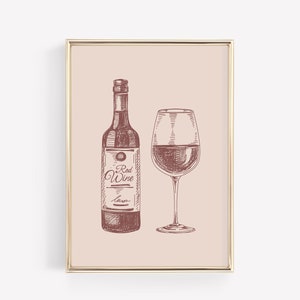 May include: A framed print featuring a sketch of a wine bottle and a wine glass, both filled with red wine. The bottle has a label that reads "Red Wine". The artwork is in shades of brown and red on a light pink background.
